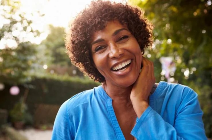 Woman smiling outdoors — individualized menopause symptom management